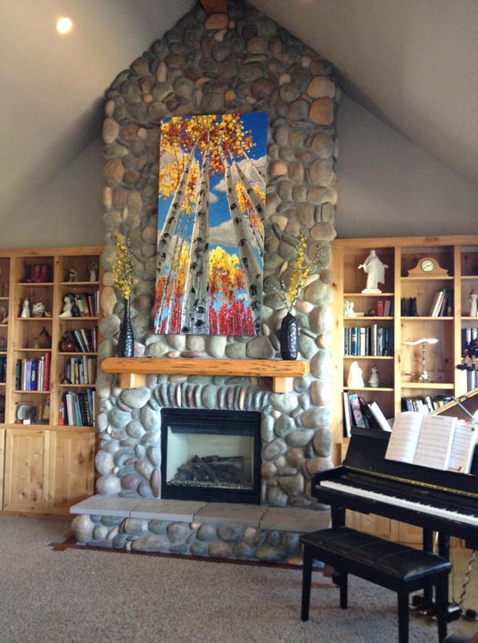 Above the fireplace in the Broesder home — palette knife painting by Jennifer Vranes