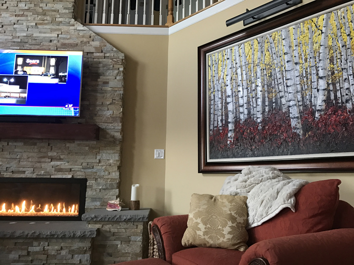 Content above the fireplace in Jill and Howie's home — palette knife painting by Jennifer Vranes
